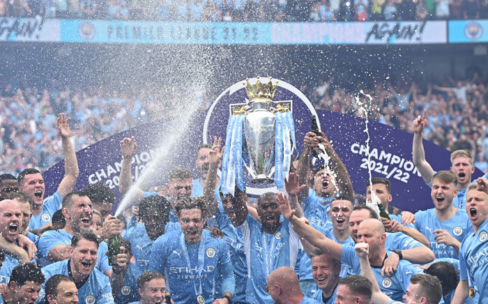 Manchester City midfielder Fernandinho lifts the Premier League trophy as City players celebrate on the pitch after the English Premier League football match between Manchester City and Aston Villa at the Etihad Stadium in Manchester, north west England, on 22 May 2022. Picture: Oli SCARFF/AFP