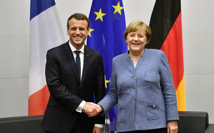 French President Emmanuel Macron (R) shakes hands with German Chancellor Angela Merkel during bilateral talks on the sidelines of the UN conference on climate change (COP23) on 15 November 2017 in Bonn. Picture: AFP