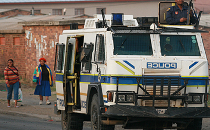 Police patrol the street after a violent protest. Picture: Taurai Maduna/ Eyewitness News