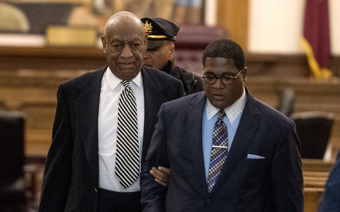 FILE: Bill Cosby (left) is escorted outside Montgomery County Courtroom during a pretrial hearing in his sexual assault trial on 3 April 2017 in Norristown, Pennsylvania. Picture: AFP