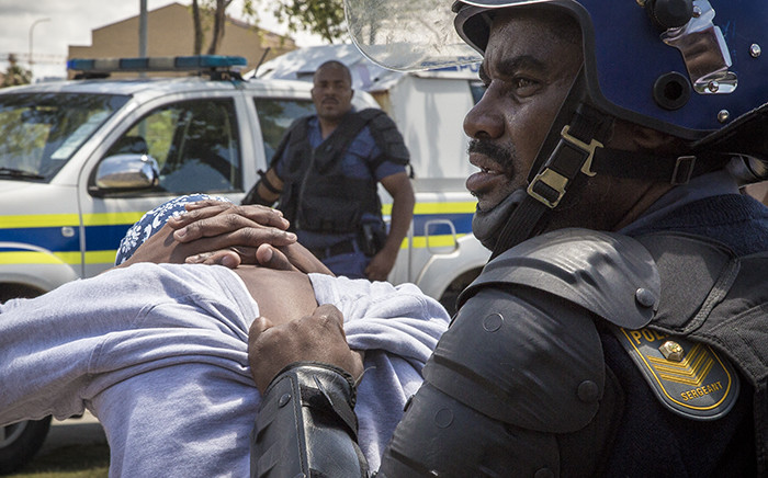 A student is detained by a public order police officer at the Cape Peninsula University of Technology. Picture: Thomas Holder/EWN.