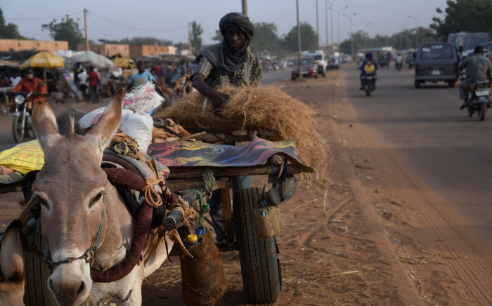 Seydou Haoudji, a man living in Zontondi in an area, affected with an alimentary crisis, arrives to sell some hay in Niamey on 28 November 2021. Picture: AFP