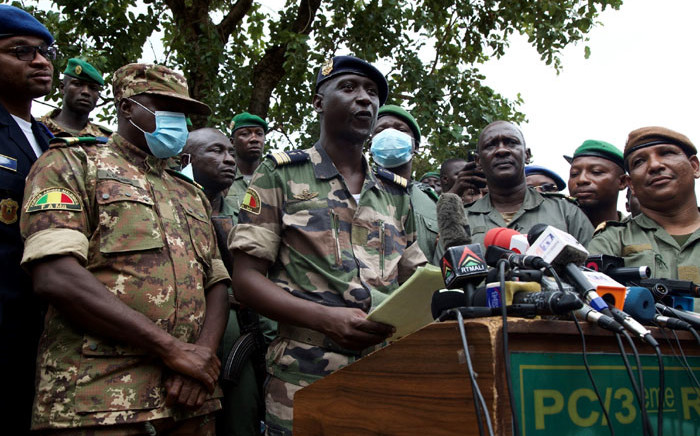 Malian Air Force deputy chief of staff Ismael Wague (front row 2nd L) speaks during a press conference in Kati, Mali on 19 August 2020. Coup leaders in Mali faced a wave of international pressure a day after they forced out Malian President Ibrahim Boubacar Keita weakened by months of mass protests. Picture: AFP