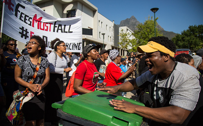 A UCT FeesMustFall protester drums on a dustbin during the UCT protests on lower campus. Picture: Anthony Molyneaux/EWN.