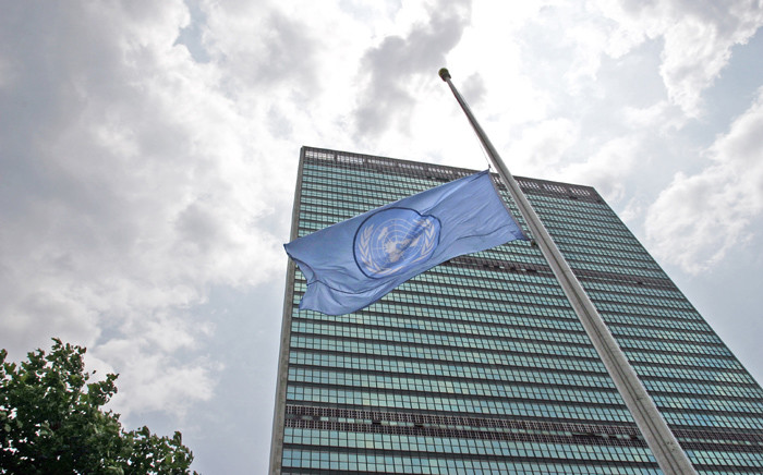 A view of the Secretariat Building, with a flag flying in the foreground, at United Nations headquarters in New York. Picture: United Nations Photo.