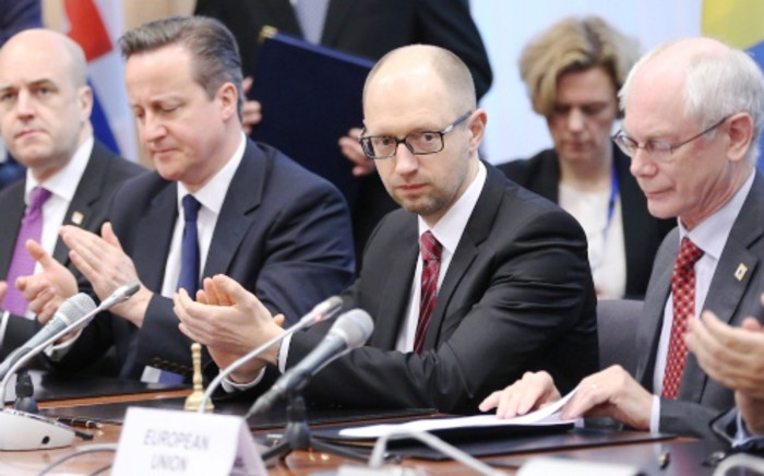 Ukrainian Prime Minister Arseniy Yatsenyuk (2nd-R) meets with EU leaders during the signing of a landmark political cooperation accord on 21 March. Picture:AFP.