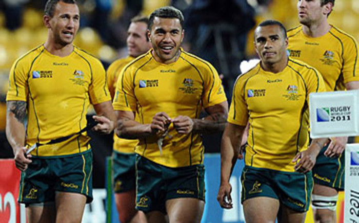 Wallabies fly-half Quade Cooper, wing Digby Ioane and scrum-half Will Genia celebrate after the 2011 Rugby World Cup quarter-final match on 9 October. Picture: AFP