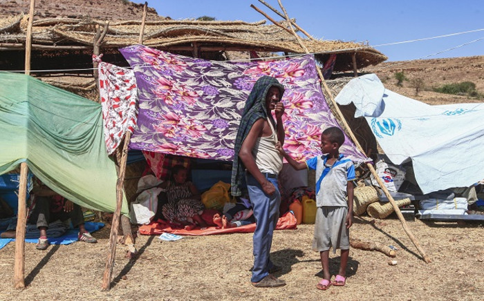 FILE: Ethiopian refugees who fled fighting in Tigray province stand outside a hut at the Um Rakuba camp in Sudan's eastern Gedaref province, on 16 November 2020. Picture: AFP. 