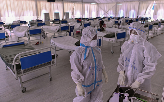 FILE: Medical staff in personal protective equipment (PPE) prepare to start their rounds in Kenyatta stadium turned into a mass isolation facility for COVID-19 patients on 3 August 2020 at Kenya's eastern town of Machakos. Picture: Tony Karumba/AFP