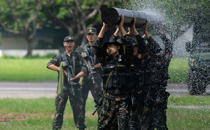 People's Liberation Army soldiers display their skills at an airbase in Hong Kong on 30 June 2018, during an event to mark the 21st anniversary of the Hong Kong handover to China. Picture: AFP