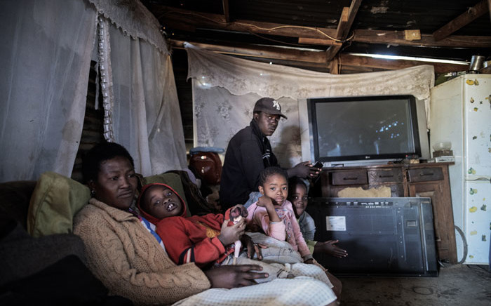Edward Mowo's family sit in their house in the Lawley informal settlement, in Lenasia, south of Johannesburg, on 17 May 2020. Edward is currently facing problems due to the lack of work during the national lockdown to help curb the spread of the coronavirus. Picture: AFP