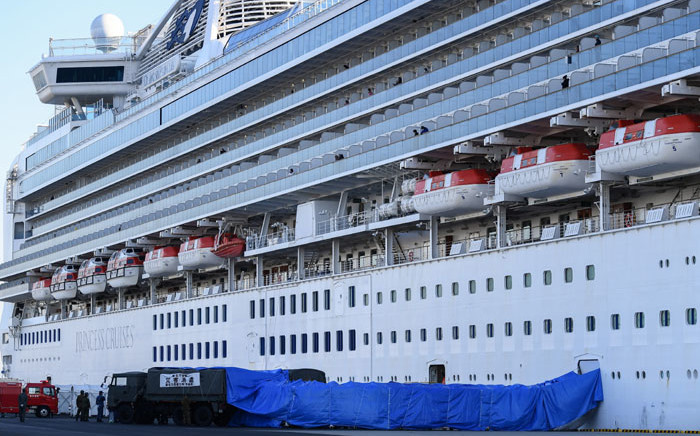 Japanese military personnel set up a covered walkway next to the 'Diamond Princess' cruise ship, with around 3,600 people quarantined onboard due to fears of the new coronavirus, at the Daikoku Pier Cruise Terminal in Yokohama port on 10 February 2020. Picture: AFP