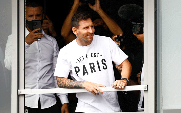 Argentinian football player Lionel Messi leans in a window as he salutes supporters after he landed on 10 August 2021 at Le Bourget airport, north of Paris, to become Paris Saint-Germain's new player following his departure from Barcelona, the club he has represented for the entirety of his 17-year professional career so far. Picture: Sameer Al-Doumy / AFP