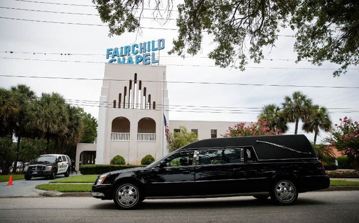 A Hearse drives past Baldwin-Fairchild Funeral Home where a wake for Christopher “Dru” Leinonen was taking place, 17 June, 2016 in Orlando, Florida. Picture: AFP.