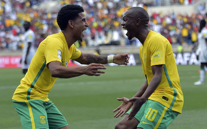 FILE: South Africa's Thulani Serero (R) celebrates with Keegan Dolly (L) after scoring a goal. Picture: AFP