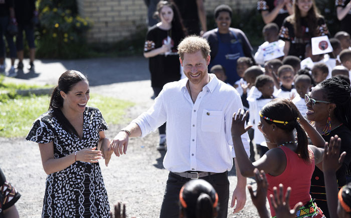 FILE: Prince Harry, Duke of Sussex and Meghan Duchess of Sussex arrive to visit 'Justice desk', an NGO in the township of Nyanga in Cape Town, as they begin their tour of the region on 23 September 2019. Picture: AFP