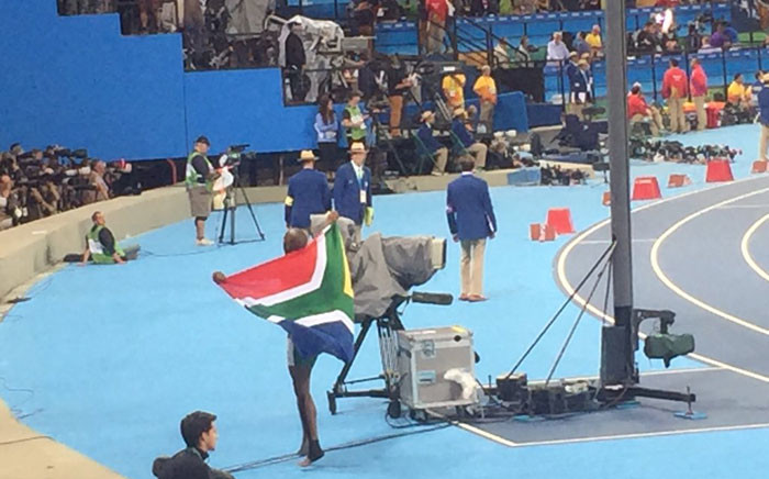 Luvo Manyonga, draped in the South African flag, after winning silver in the long jump final in Brazil. Picture: Twitter @MbalulaFikile.