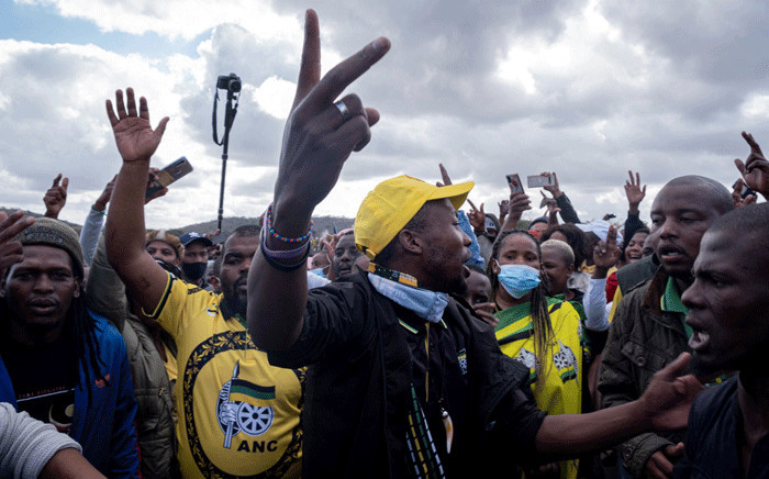 Supporters gesture as they gather in front of former South African president Jacob Zuma’s rural home in Nkandla on July 4, 2021. On July 3, 2021, hundreds of supporters gathered to show solidarity for former South African president Jacob Zuma outside his Nkandla homestead, as the deadline looms for him to surrender to the authorities. Picture: Emmanuel Croset / AFP
