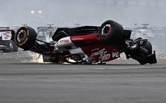Alfa Romeo's Chinese driver Zhou Guanyu skids across the track after a collision with Mercedes' British driver George Russell (unseen) at the start of the Formula One British Grand Prix at the Silverstone motor racing circuit in Silverstone, central England on 3 July 2022. Picture: Ben Stansall/AFP
