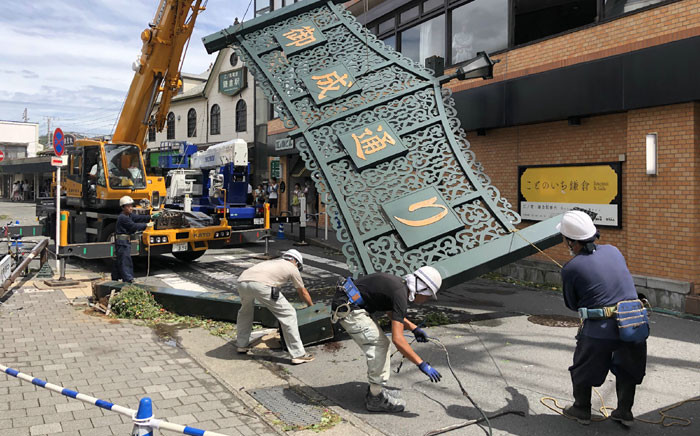 Workers remove a fallen signboard hit by typhoon Faxai in Kamakura, Kanagawa prefecture on 9 September 2019. Picture: AFP