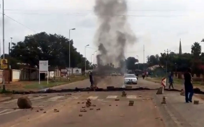  Protesters block roads with burning tyres and rocks as they shut down the area in Hammanskraal. Picture: EWN