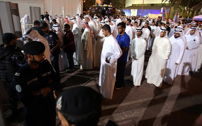 Kuwaiti mourners queue to be searched by security members outside the Sunni Grand Mosque on 27 June, 2015 as they arrive to give their condolences to the families of the victims of a suicide bombing which took place at the Shiite al-Imam al-Sadeq mosque the previous day, in Kuwait City. Picture: AFP.