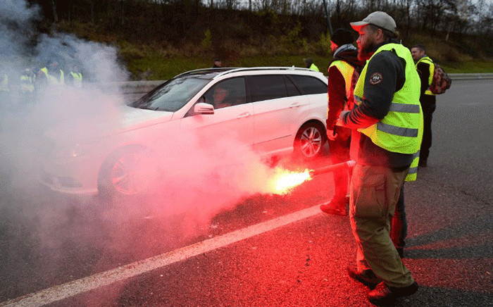 "Yellow Vest" (Gilets Jaunes) protesters take part in a free-passage operation at the toll collection area on the A31 motorway in Beaumont, eastern France, on November 24, 2018, during a demonstration to protest against high fuel prices and living costs. Picture: AFP.
