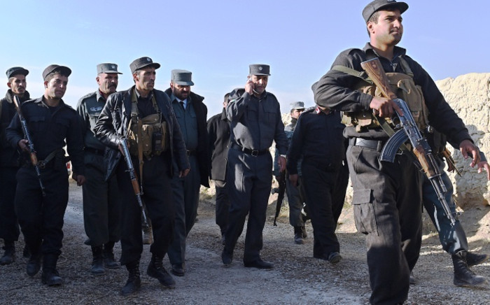 FILE: In this photograph taken on November 18, 2014, Kabul's police chief general Zahir Zahir (3rd R) talks on the phone as he arrives at the site of a suicide attack at the entrance of a foreign-run compound in Kabul. Picture: EPA.