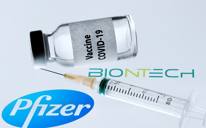 FILE: This file picture taken on November 23, 2020 shows a bottle reading "Vaccine COVID-19" next to US pharmaceutical company Pfizer and German biotechnology company BioNTech logos. Picture: AFP