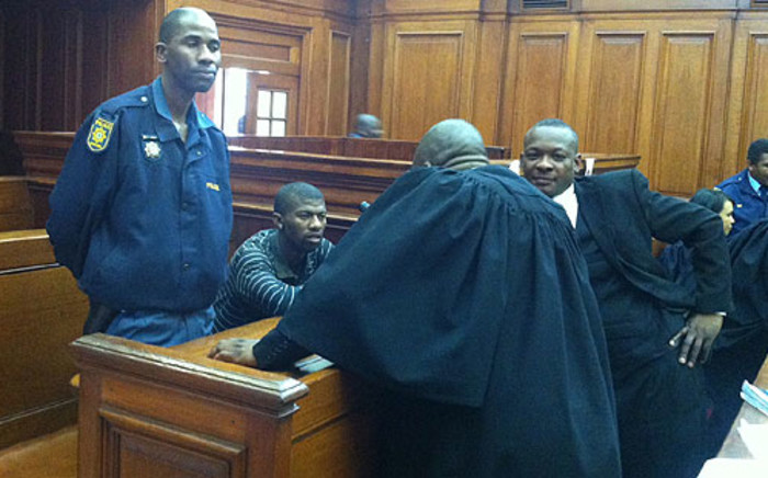 Alleged gunman in the Anni Dewani murder, Xolile Mngeni, chats with his lawyers on 30 august 2012. Picture: Nathan Adams/EWN