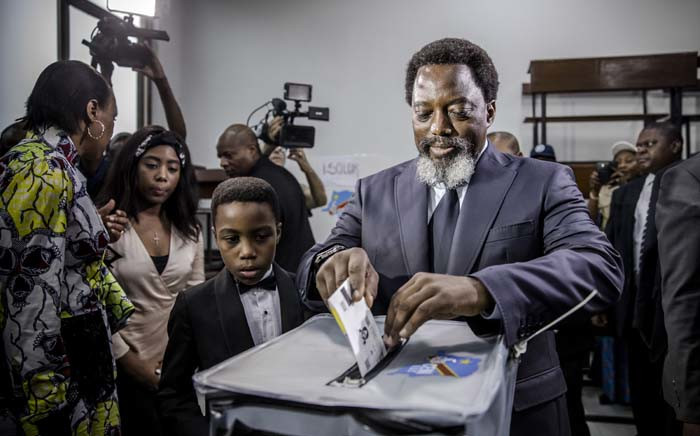 President of the Democratic Republic of Congo Joseph Kabila casts his vote along with his family at the Insititut de la Gombe polling station during general elections in Kinshasa on 30 December 2018. Picture: AFP