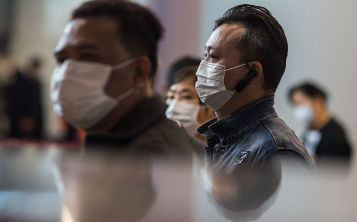 Passengers at a train station connecting Hong Kong to mainland China, wearing masks as a preventative measure following a coronavirus outbreak which began in the Chinese city of Wuhan. Picture: AFP.