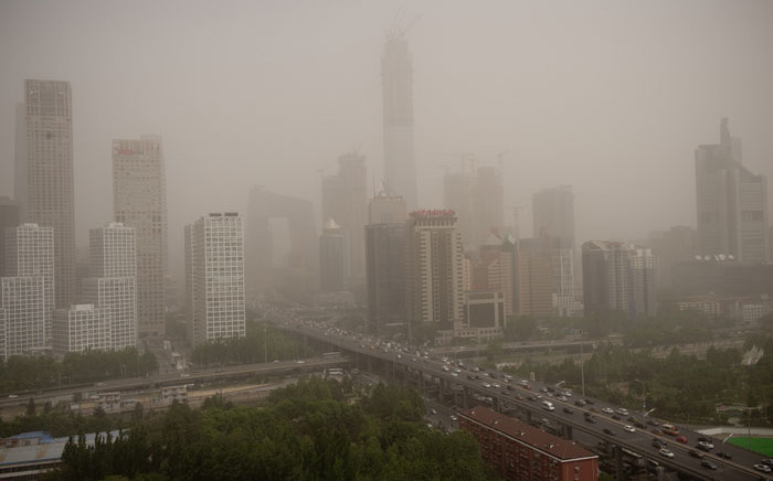 FILE: Parts of the central business district are shrouded in a dust storm in Beijing. Picture: AFP