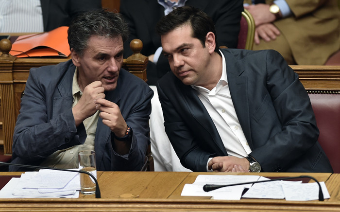 Greek Prime Minister Alexis Tsipras (R) and Finance Minister Eyclid Tsakalotos attend a parliamentary session in Athens on 15 July, 2015. Picture: AFP.