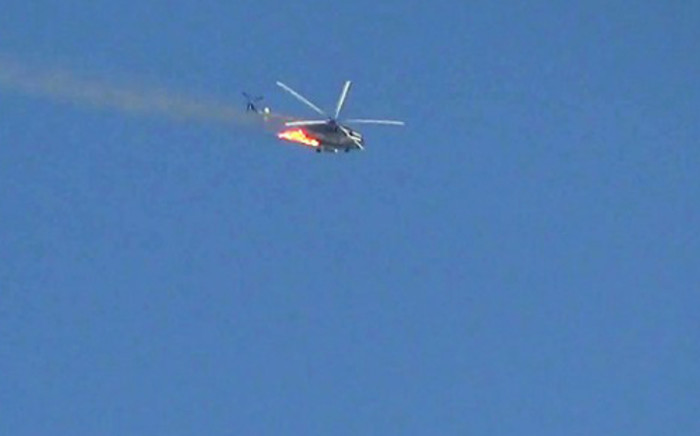 An image grab that was taken from a video uploaded on YouTube on August 27, 2012 showing a burning Syrian combat helicopter crashing. Picture: AFP