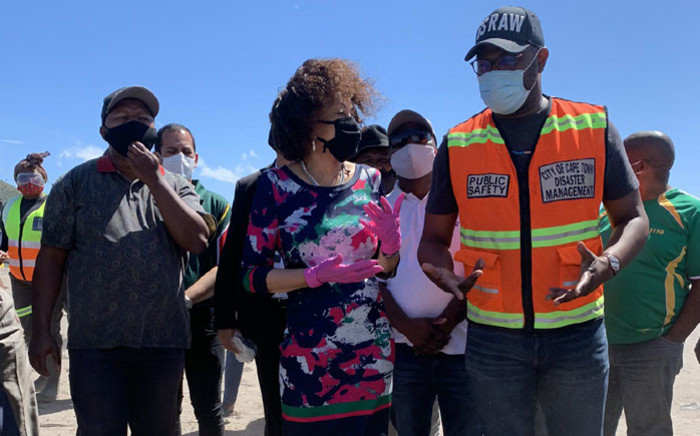 Human Settlements Minister Lindiwe Sisulu (centre) assesses the situation in Masiphumelele on 21 December 2020 following a fire that displaced thousands of people on 17 December 2020. Picture: Kaylynn Palm/EWN