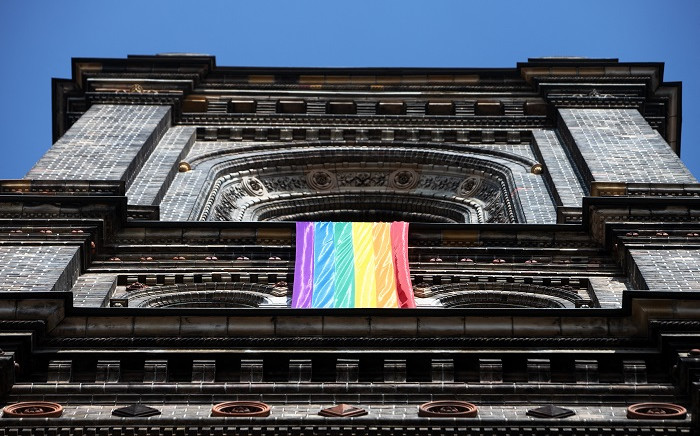 A LGBT rainbow flag hangs from on the steeple of the parish church in the Breitenfeld quarter in Vienna, on March 25, 2021. Picture: Alex Halada / AFP.
