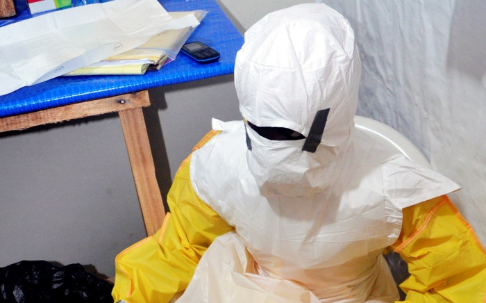 FILE: A picture taken on 24 July 2014 shows a staff member of the Christian charity Samaritan's Purse wearing protective gear to enter a treatment room in the ELWA hospital in the Liberian capital Monrovia. Picture: AFP.