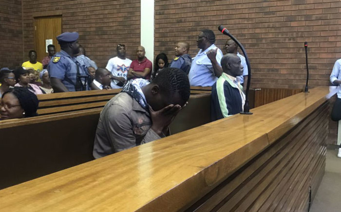 Ernest Mabaso (head in hands) and Fita Khupe (right) appear in Lenasia Magistrates Court on 12 November 2018 for the murder of seven people in Vlakfontein. Picture: Bonga Dlulane/EWN