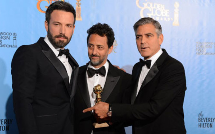 Actor/director Ben Affleck (L) poses with producers Grant Heslov (C) and George Clooney with the award for best motion picture drama for "Argo" at the Golden Globes awards ceremony in Beverly Hills on 13 January 2013. Picture: AFP