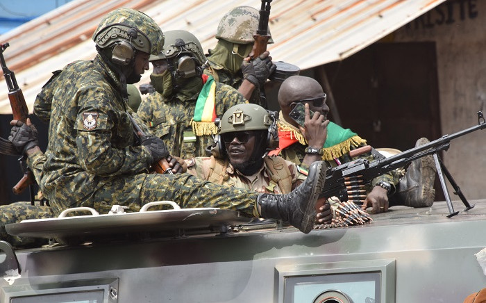 Members of Guinea's armed forces celebrate after the arrest of Guinea's president, Alpha Conde, in a coup d'etat in Conakry on September 5, 2021. Picture: Cellou Binani / AFP.