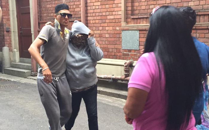 The woman accused of abducting Zephany Nurse is being covered by her supporters immediately and bundled her in a car after her court appearance on 6 March 2015 in Cape Town. Picture:Monique Mortlock/EWN. 