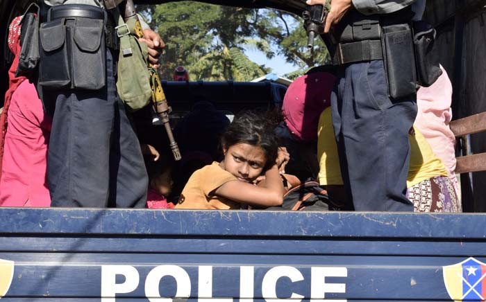 FILE: Myanmar police escort Rohingya Muslims back to their camp in Sittwe, Rakhine state, on 30 November 2018. Nearly 100 Rohingya Muslims were forced back to Myanmar's Rakhine state after being detained at sea en route to Malaysia, police said on 28 November, stirring fears of a fresh refugee boat crisis. Picture: AFP