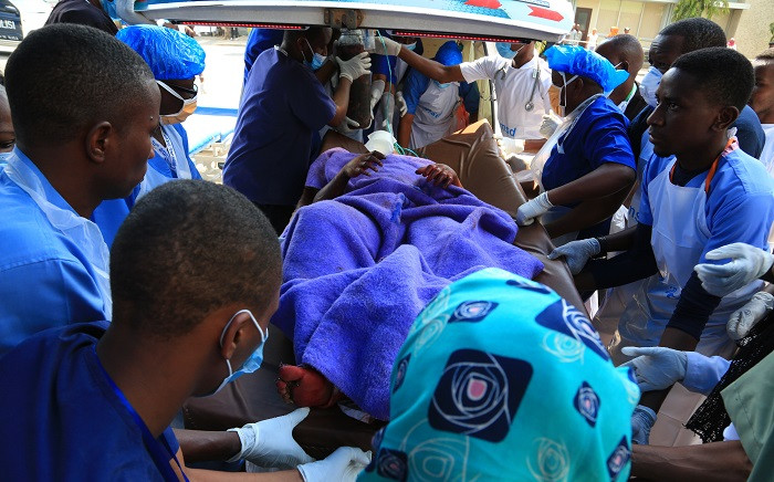 Tanzanian health workers carry a wounded man from a military helicopter at Jangwani, in Dar es Salaam on 11 August 2019, the day after a fuel tanker explosion in the town of Morogoro, 200 kilometres (120 miles) west of the Tanzanian capital. Picture: AFP
