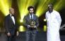 Confederation of African Football (CAF) President Ahmad Ahmad (L) poses after he hands over the 2018 African Footballer of the Year Award to Liverpool's Egyptian forward Mohamed Salah (C) alongside Liberian President George Weah during an award ceremony in Dakar, Senegal on 8 January 2019. 