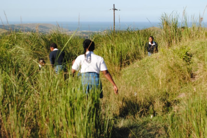Girls at Sea View Senior Secondary School relieve themselves in the tall grass.
