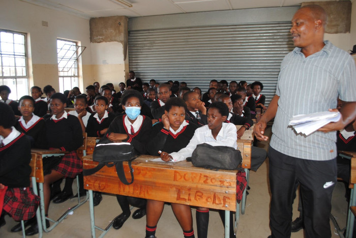 Lakhe Pikiso, deputy principal at Ntapane Junior Senior Secondary School, battles to teach in an overcowded classroom.