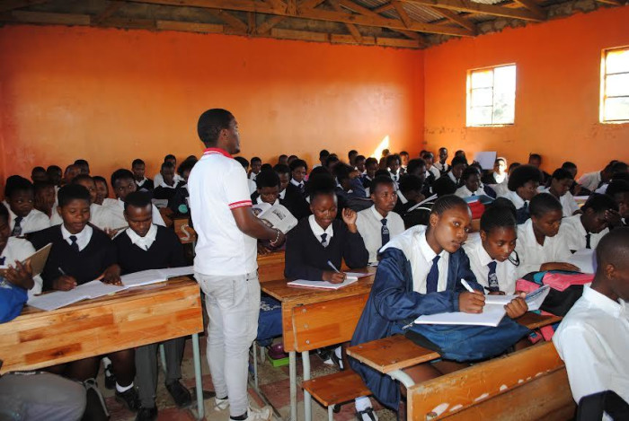Lwando Mgotywa teaching in an overcrowded classroom at Sea View Senior Secondary School.