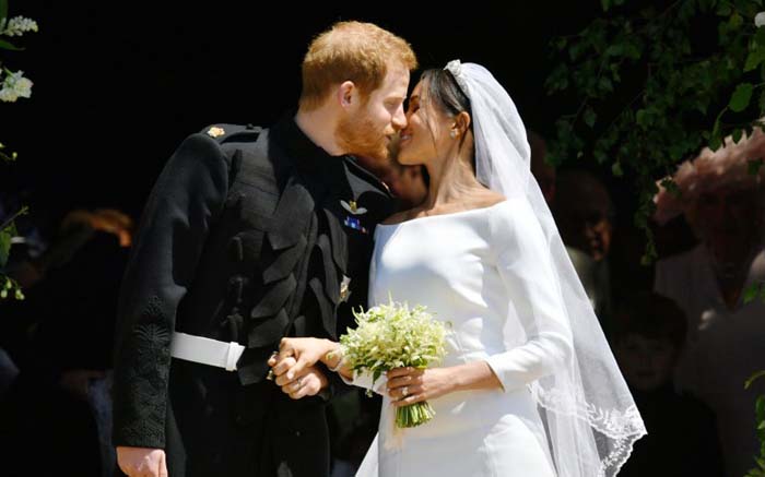 Britain's Prince Harry, Duke of Sussex kisses his wife Meghan, Duchess of Sussex as they leave from the West Door of St George's Chapel, Windsor Castle, in Windsor, on 19 May 2018 after their wedding ceremony. Picture: AFP