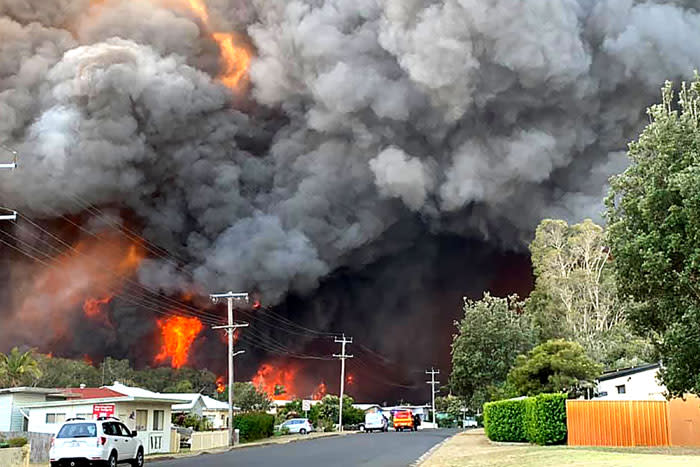 FILE: This handout picture taken and received from Kelly-ann Oosterbeek on 8 November 2019 shows flames from an out of control bushfire seen from a nearby residential area in Harrington, some 335 kilometers northeast of Sydney. Picture: AFP